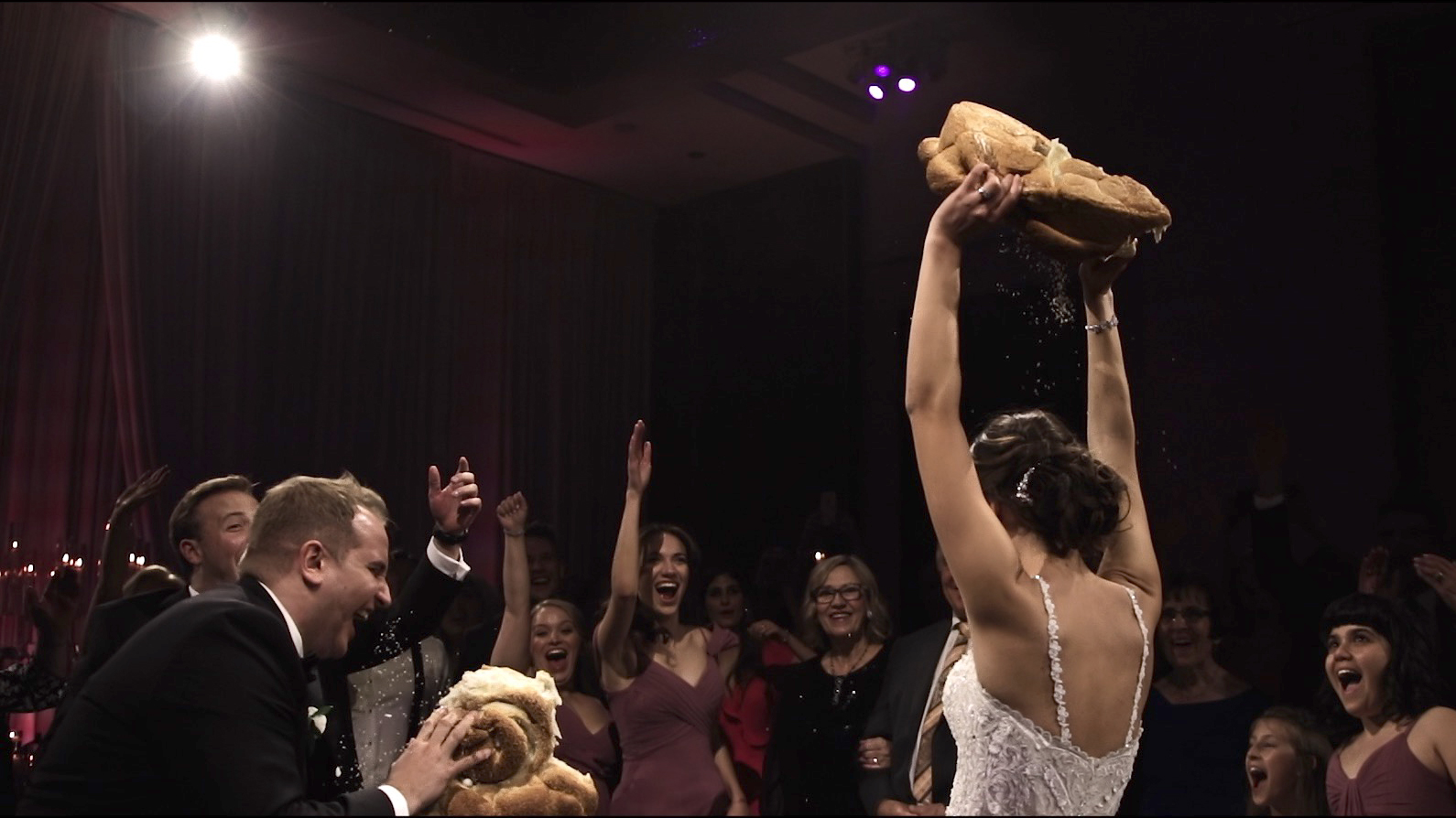 bride holding large bread